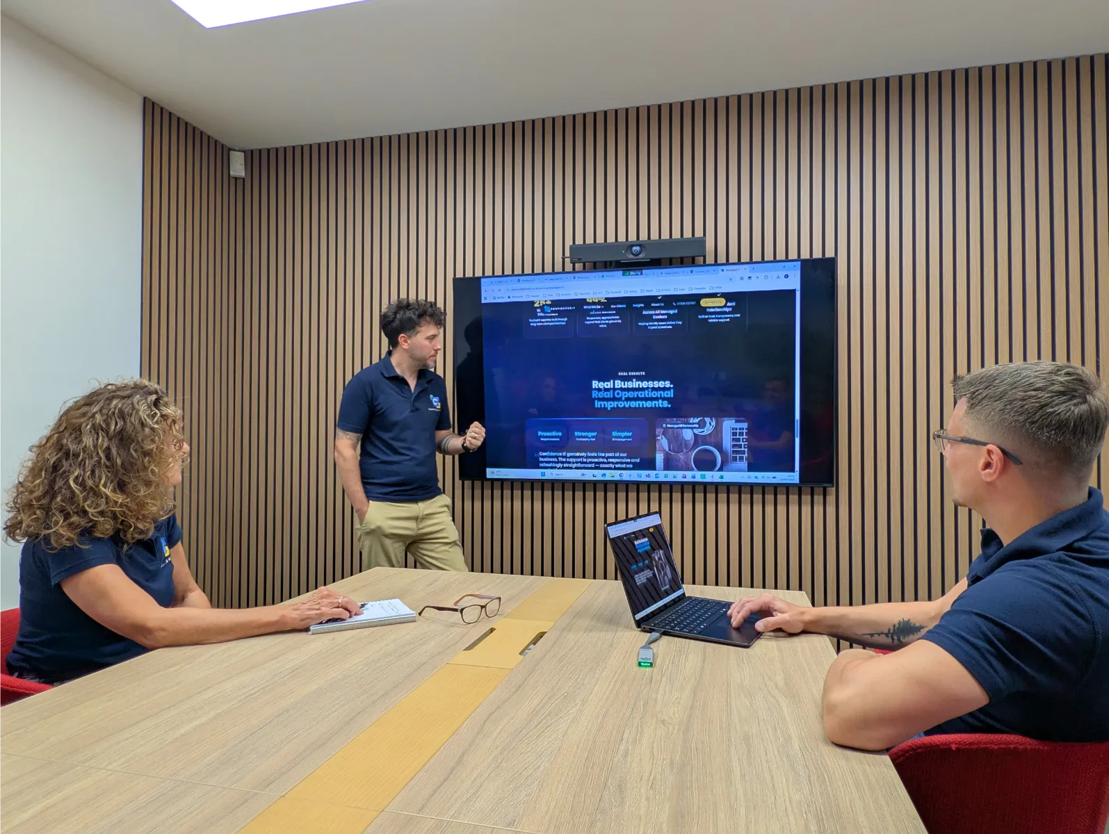 The Confidence IT team working together in a meeting room